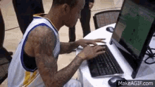 An elderly woman typing very slowly