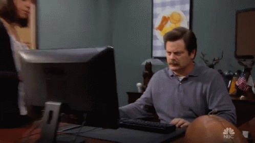Ron Swanson throwing his computer in the trash